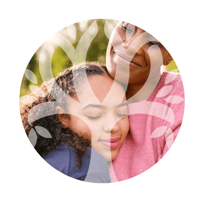 Two family members hugging beneath an opaque Wellness Institute logo